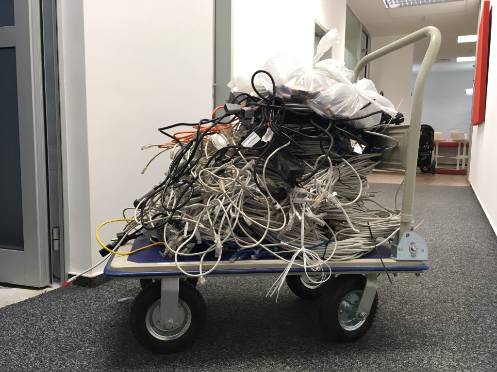 Electronic cables waste on a rolling dolly cart.