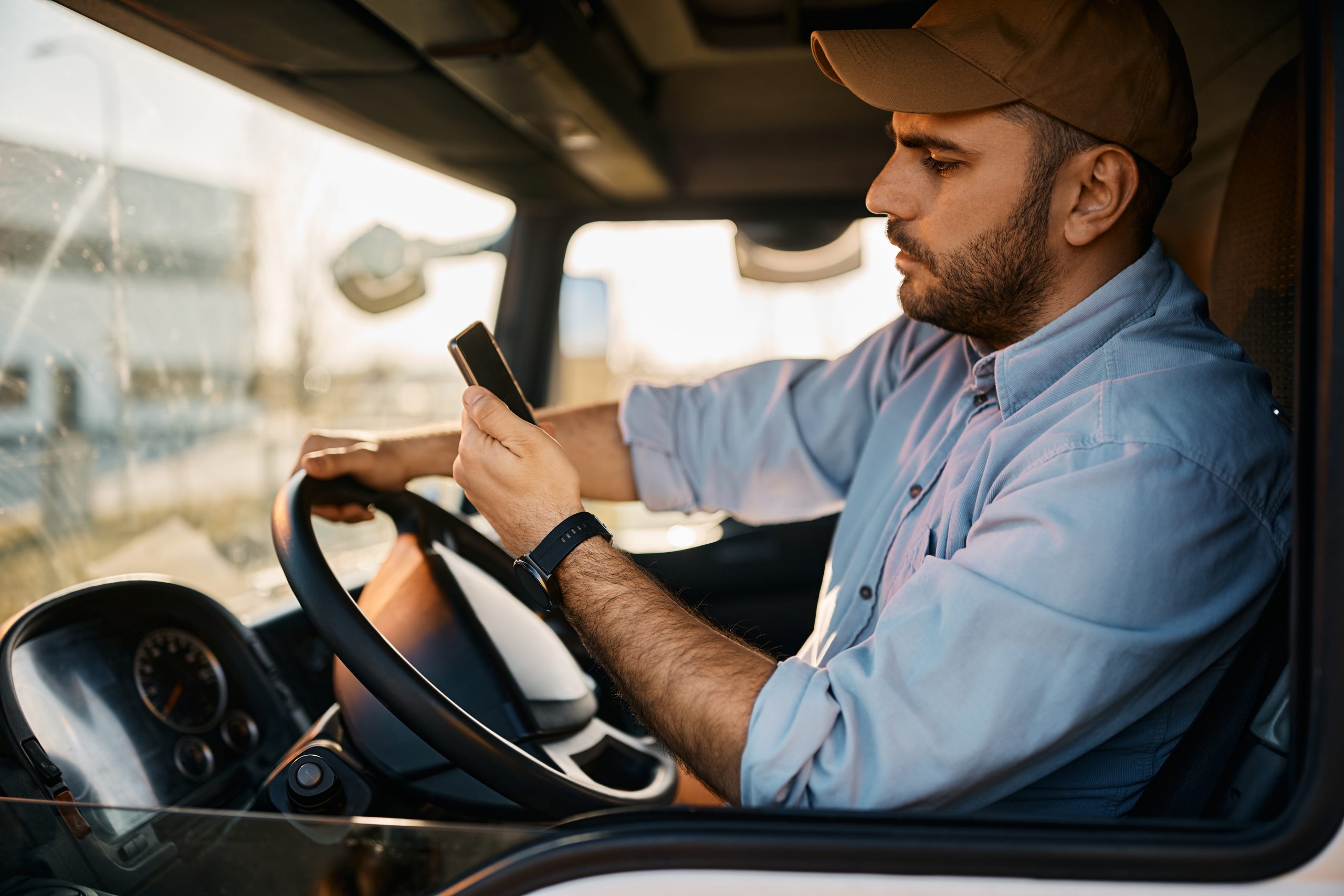 side view of truck driver reading text message on 2022 11 29 22 44 06 utc scaled
