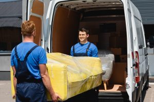 selective focus of movers holding sofa in stretch 2022 12 16 17 16 14 utc scaled